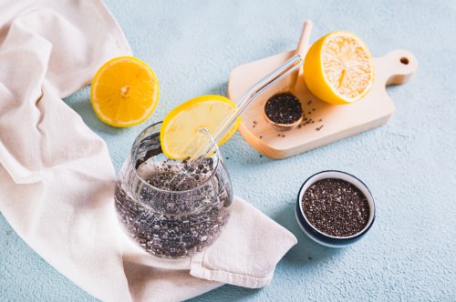 Super food cocktail chia water with lemon in a glass on the table